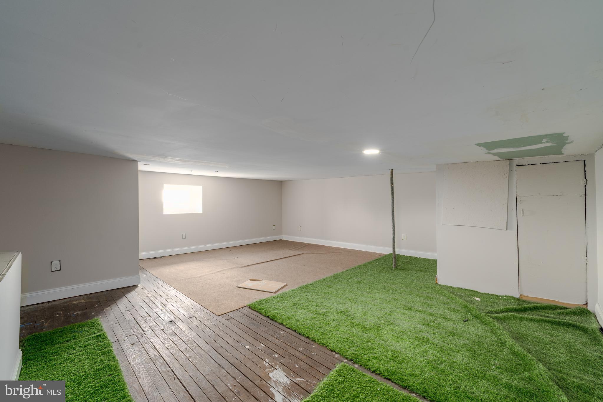 3506 Reisterstown Road Baltimore, MD 21215 - Photo 23 of 32 a view of a big room with a fireplace and a yard