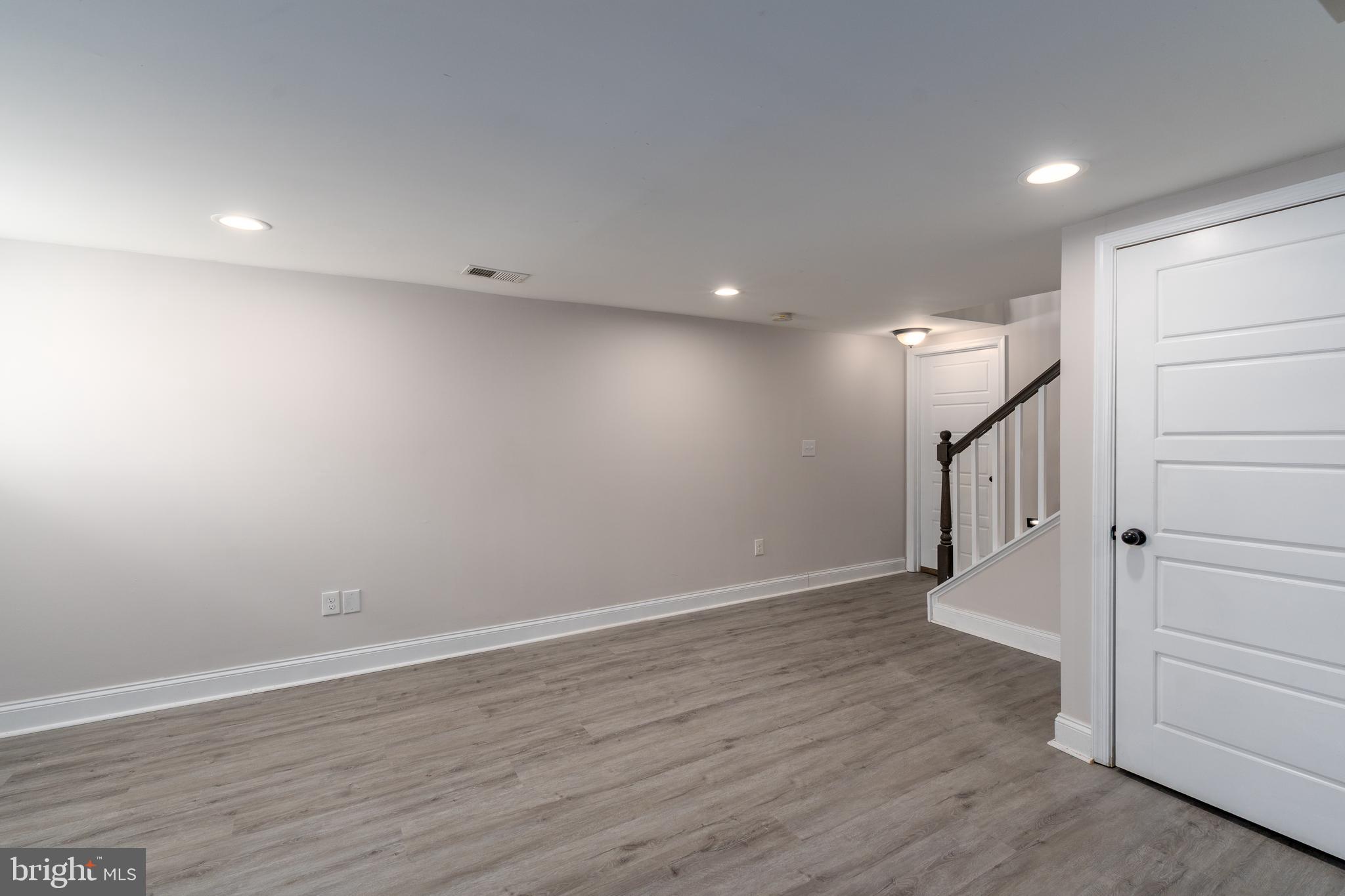 3506 Reisterstown Road Baltimore, MD 21215 - Photo 26 of 32 a view of an empty room with wooden floor and entryway
