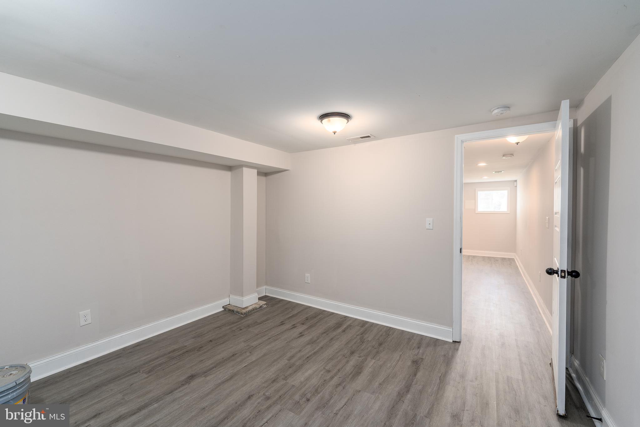 3506 Reisterstown Road Baltimore, MD 21215 - Photo 27 of 32 wooden floor in an empty room with a window