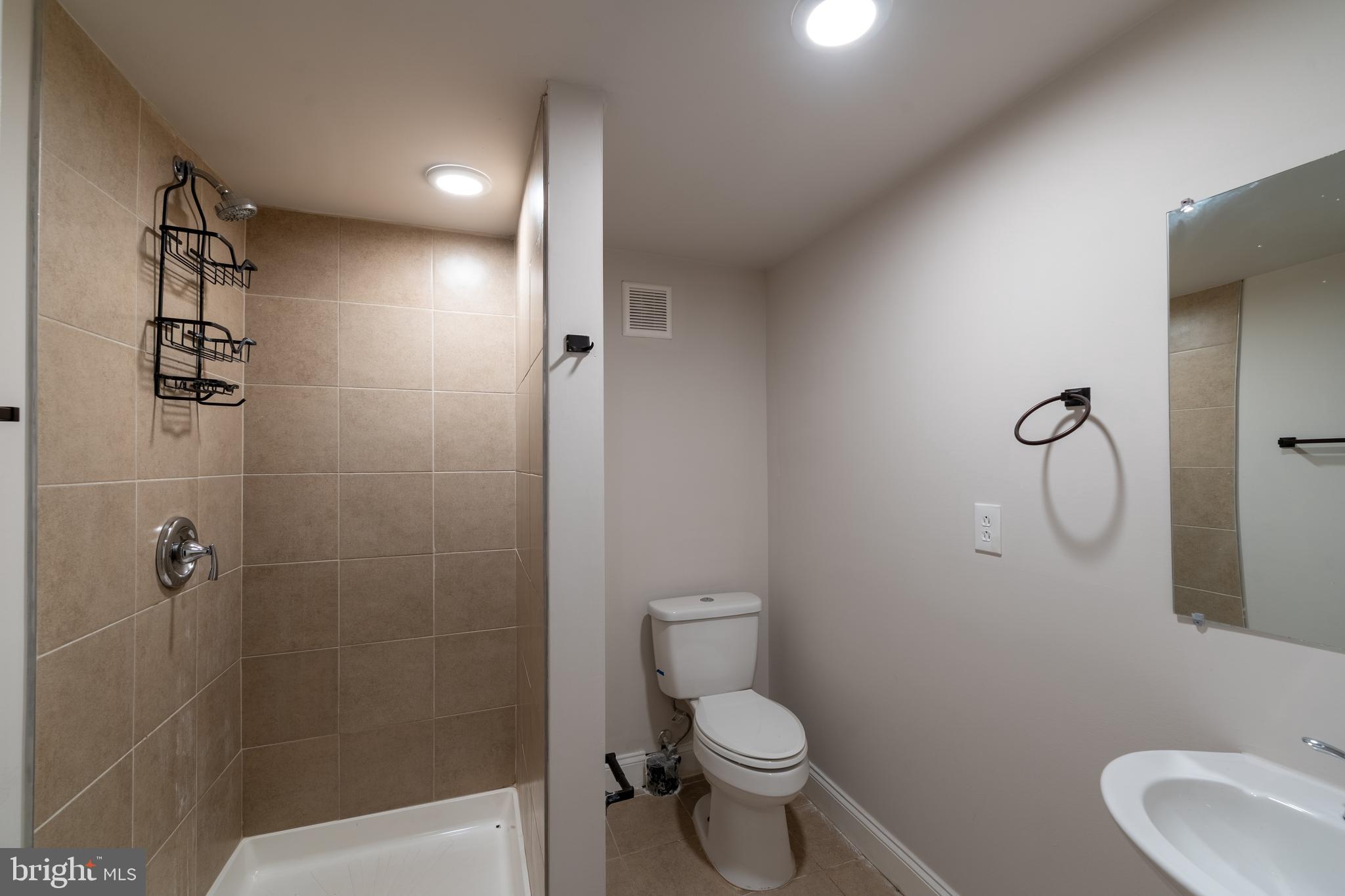 3506 Reisterstown Road Baltimore, MD 21215 - Photo 29 of 32 a bathroom with a toilet sink and shower