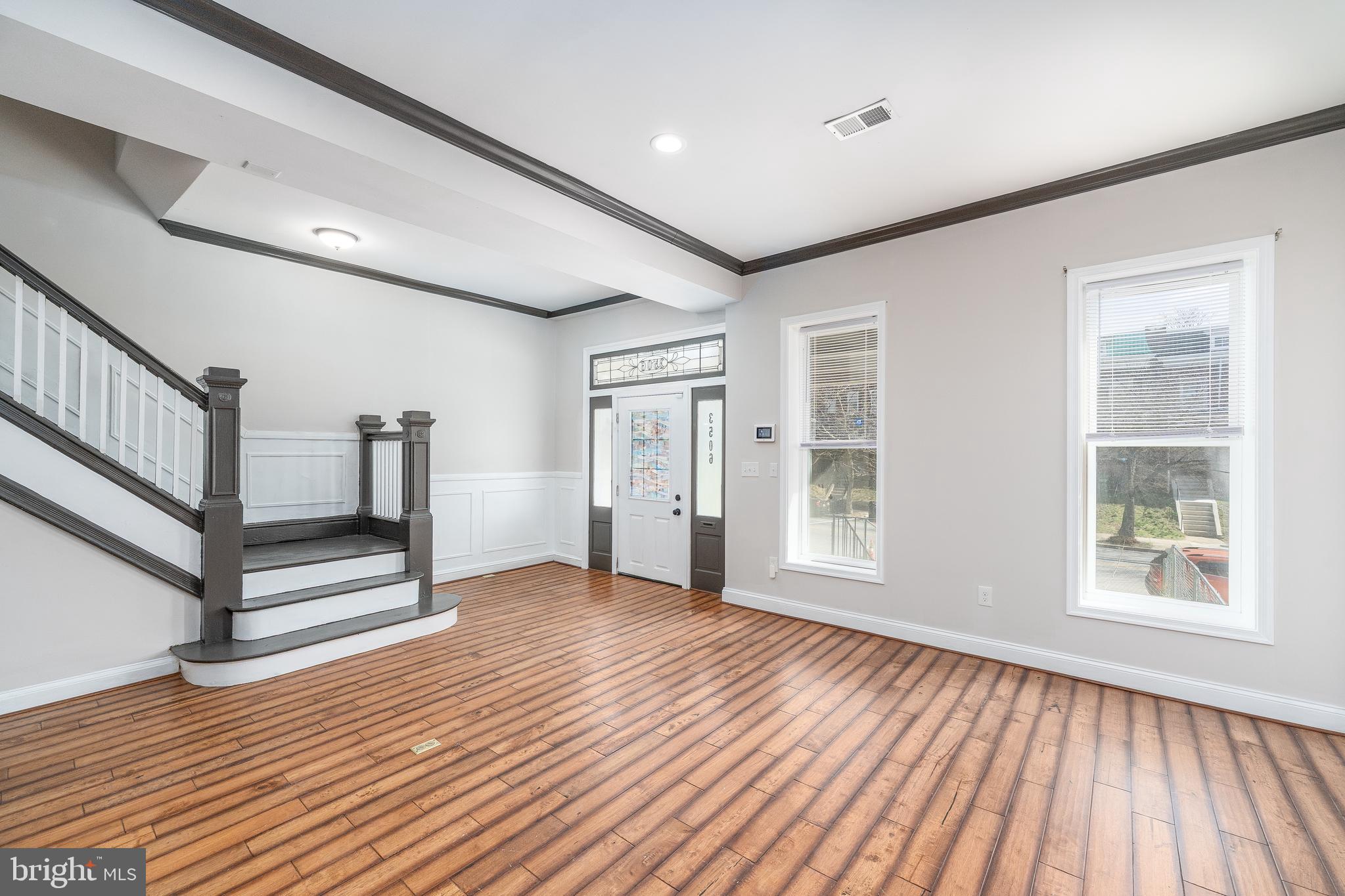3506 Reisterstown Road Baltimore, MD 21215 - Photo 7 of 32 a view of an empty room with wooden floor and a window