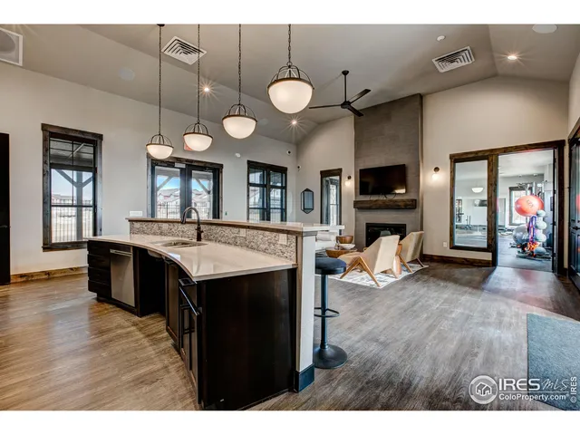 a view of living room with kitchen island furniture and a flat screen tv