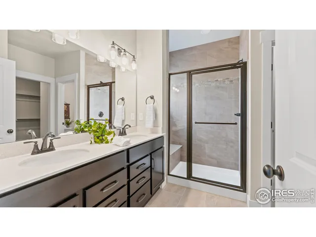 a bathroom with a sink a mirror and a shower