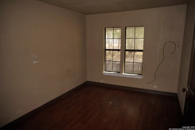 a bathroom with a sink a mirror and wooden floor