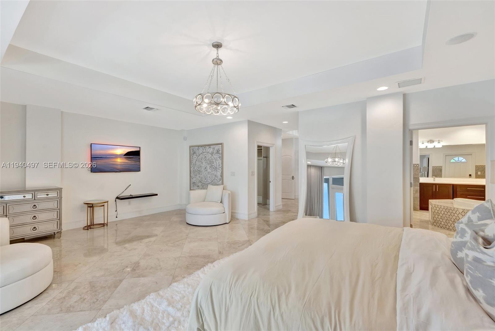 4610 Southwest 178th Avenue Southwest Ranches, FL 33331 - Photo 31 of 100 a spacious bedroom with a bed a couch and chandelier