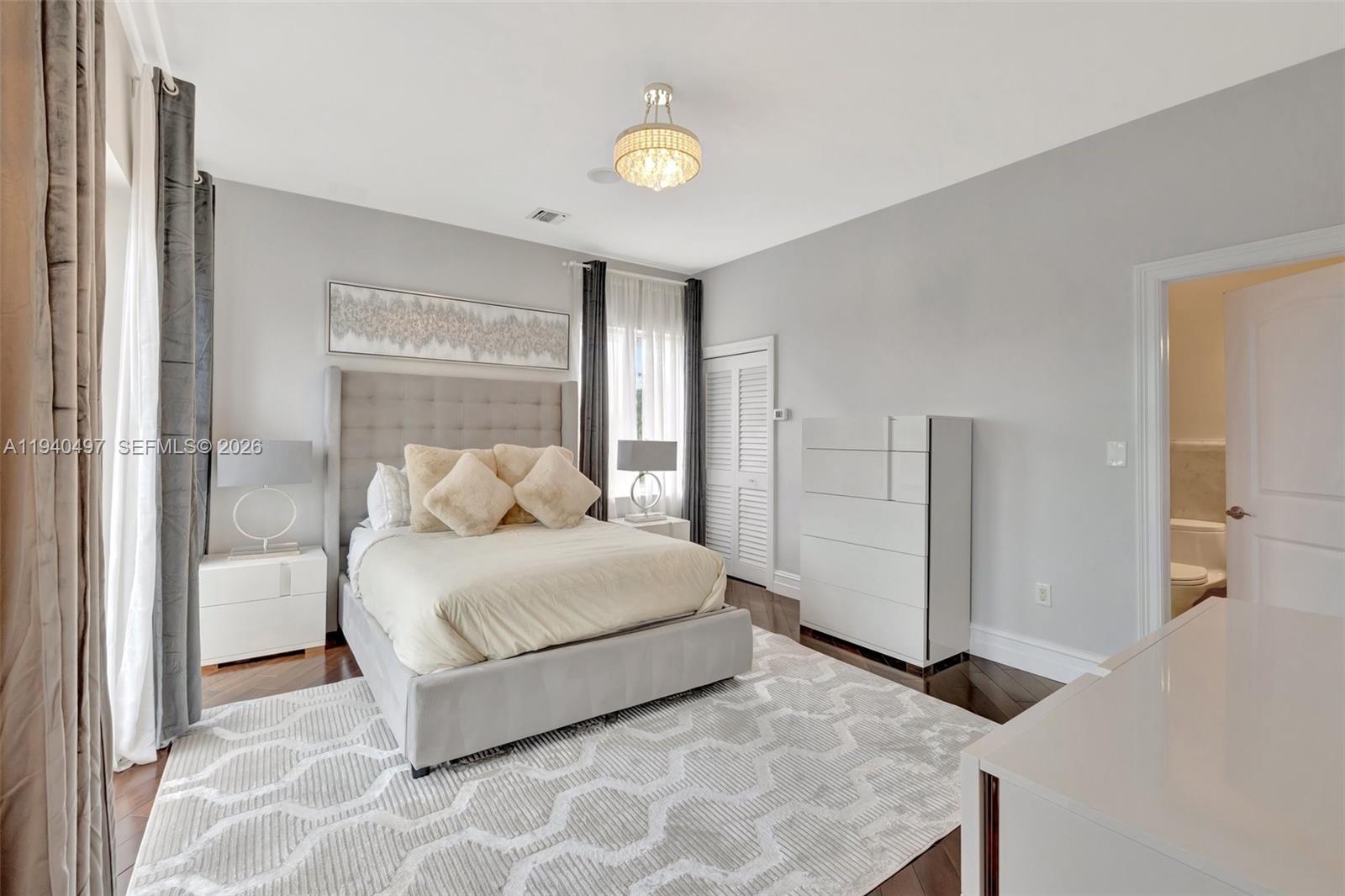 4610 Southwest 178th Avenue Southwest Ranches, FL 33331 - Photo 46 of 100 a bedroom with a bed and a lamp on dresser