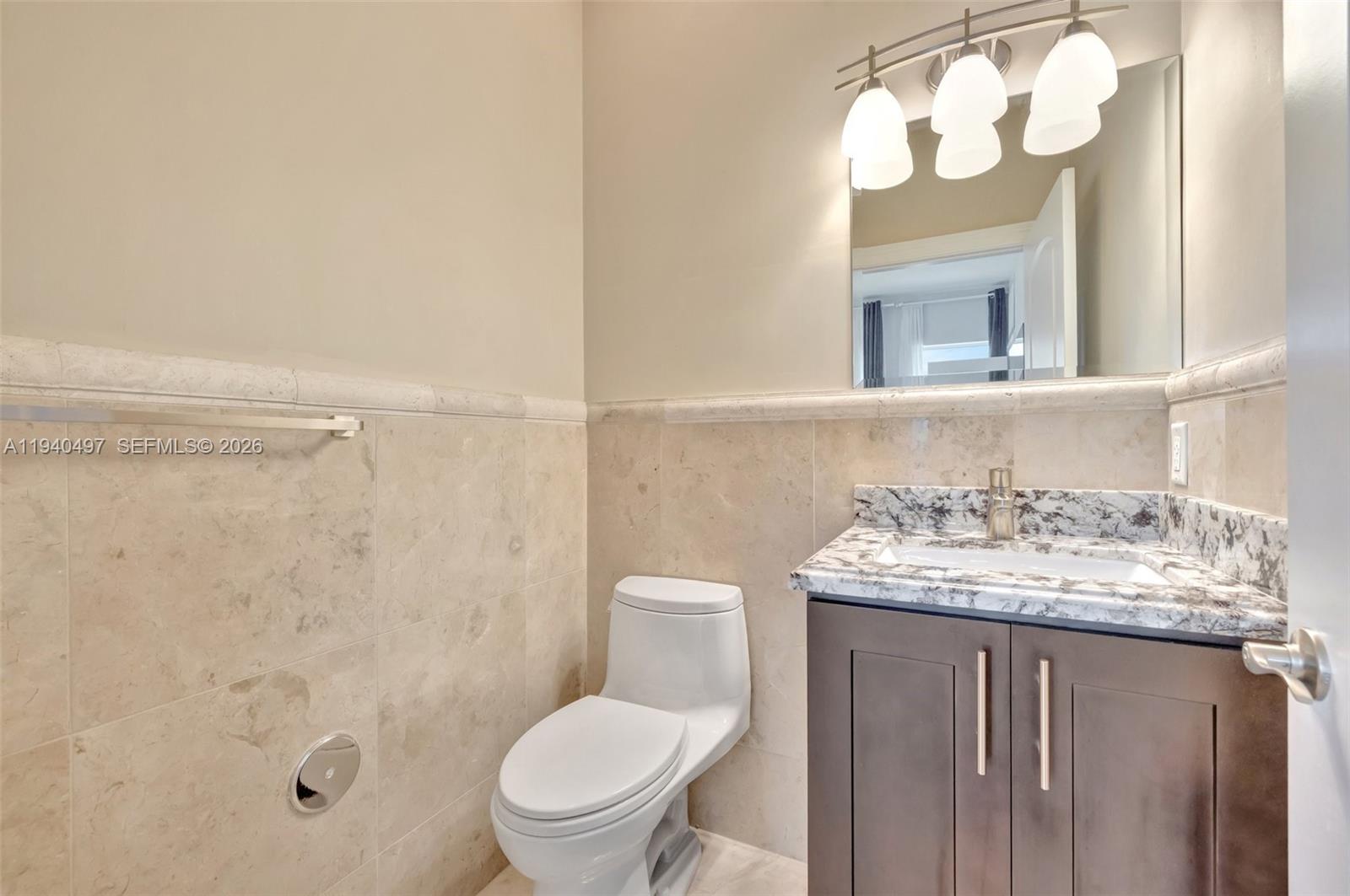 4610 Southwest 178th Avenue Southwest Ranches, FL 33331 - Photo 47 of 100 a bathroom with a granite countertop sink toilet and a mirror