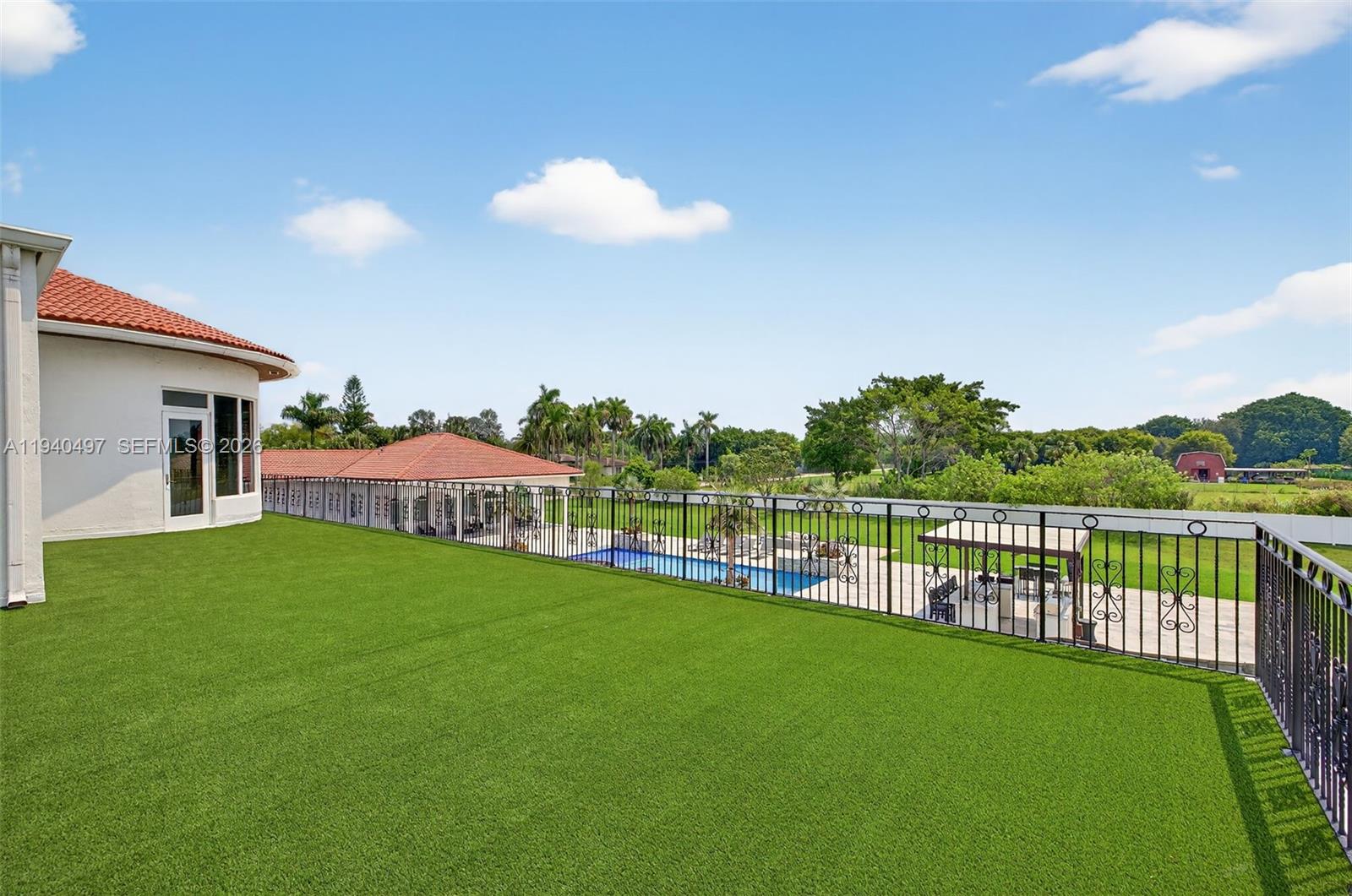 4610 Southwest 178th Avenue Southwest Ranches, FL 33331 - Photo 80 of 100 a view of a house with a backyard and a patio