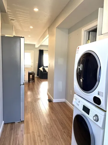 a view of kitchen and utility room with wooden floor