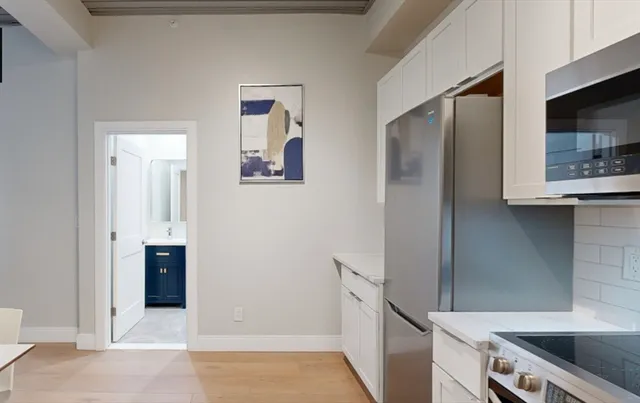 a kitchen with stainless steel appliances granite countertop a refrigerator and a sink