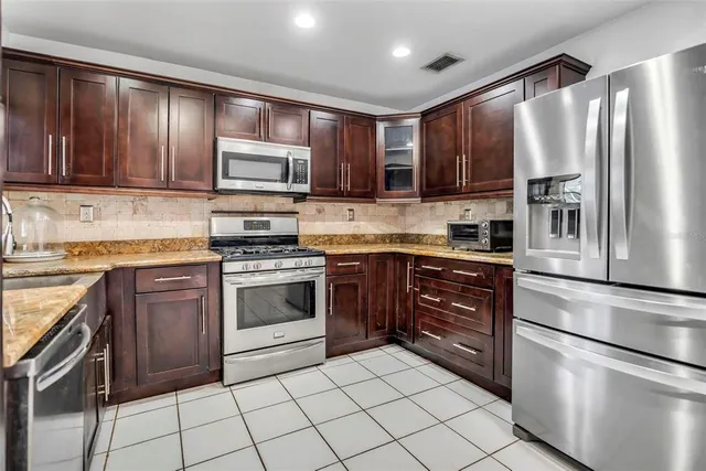 a kitchen with a stove microwave and refrigerator