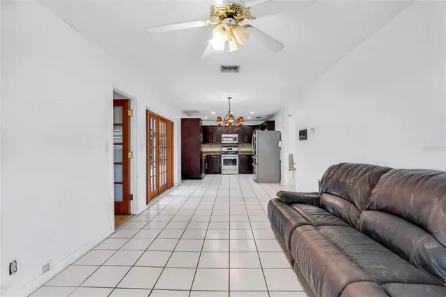a living room with furniture and a chandelier