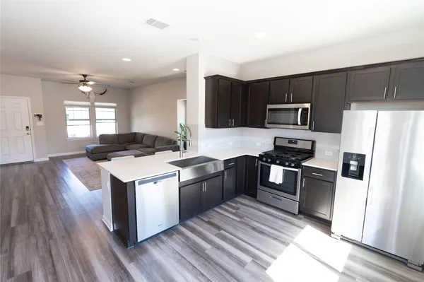 a kitchen with a sink stove and microwave