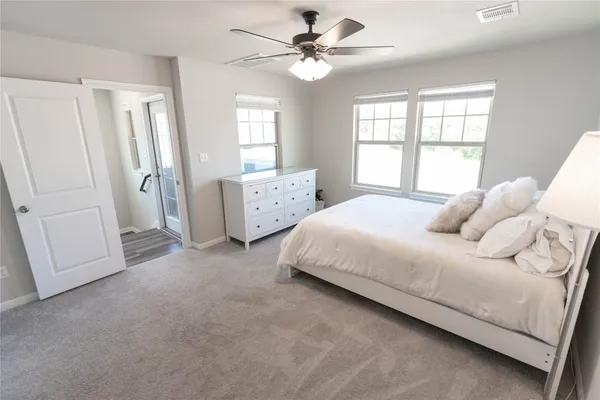 a bedroom with a bed and a mirror