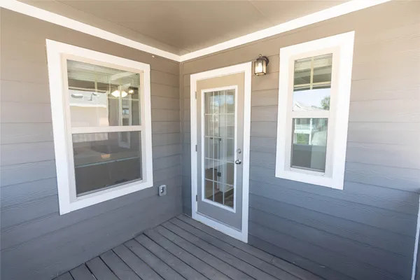 a view of balcony with wooden floor