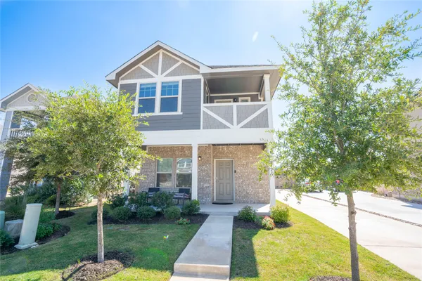 a front view of a house with a yard