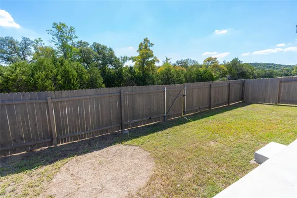an aerial view of a city with lots of residential buildings ocean and mountain view in back