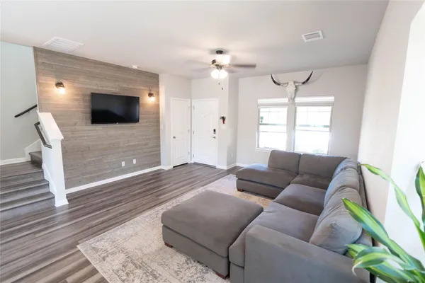 a living room with furniture and a flat screen tv