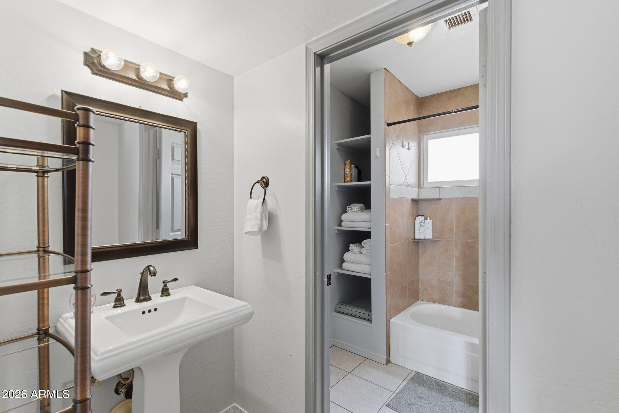 4218 West Boca Raton Road Phoenix, AZ 85053 - Photo 13 of 27 a bathroom with a sink and mirror