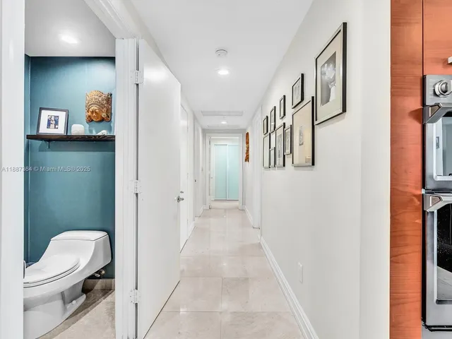 a kitchen with a sink and chairs