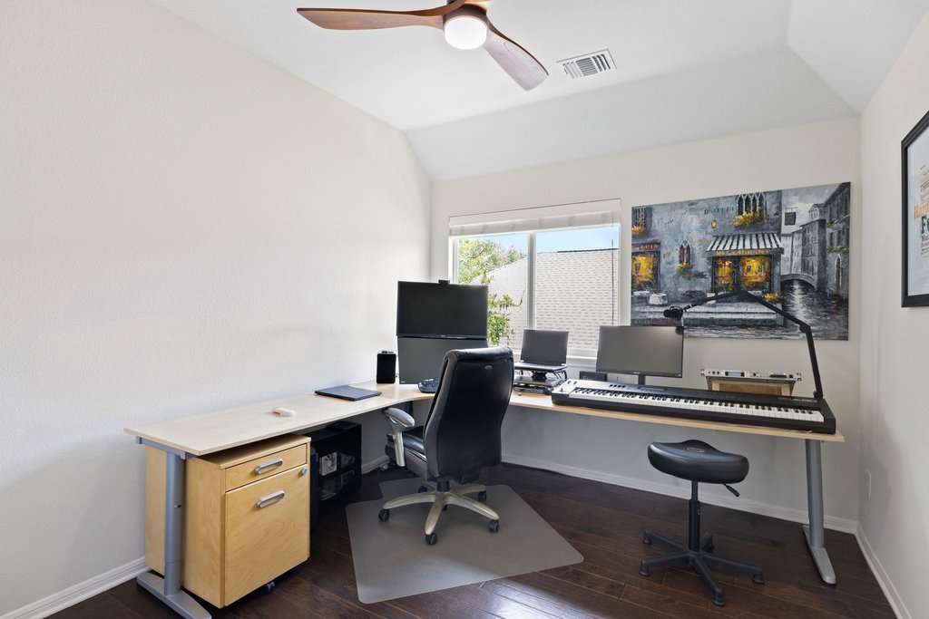 6704 Kiev Cove Austin, TX 78739 - Photo 23 of 37 A versatile home office with rich hardwood floors, an angled ceiling, and ample desk space, perfect for productivity.