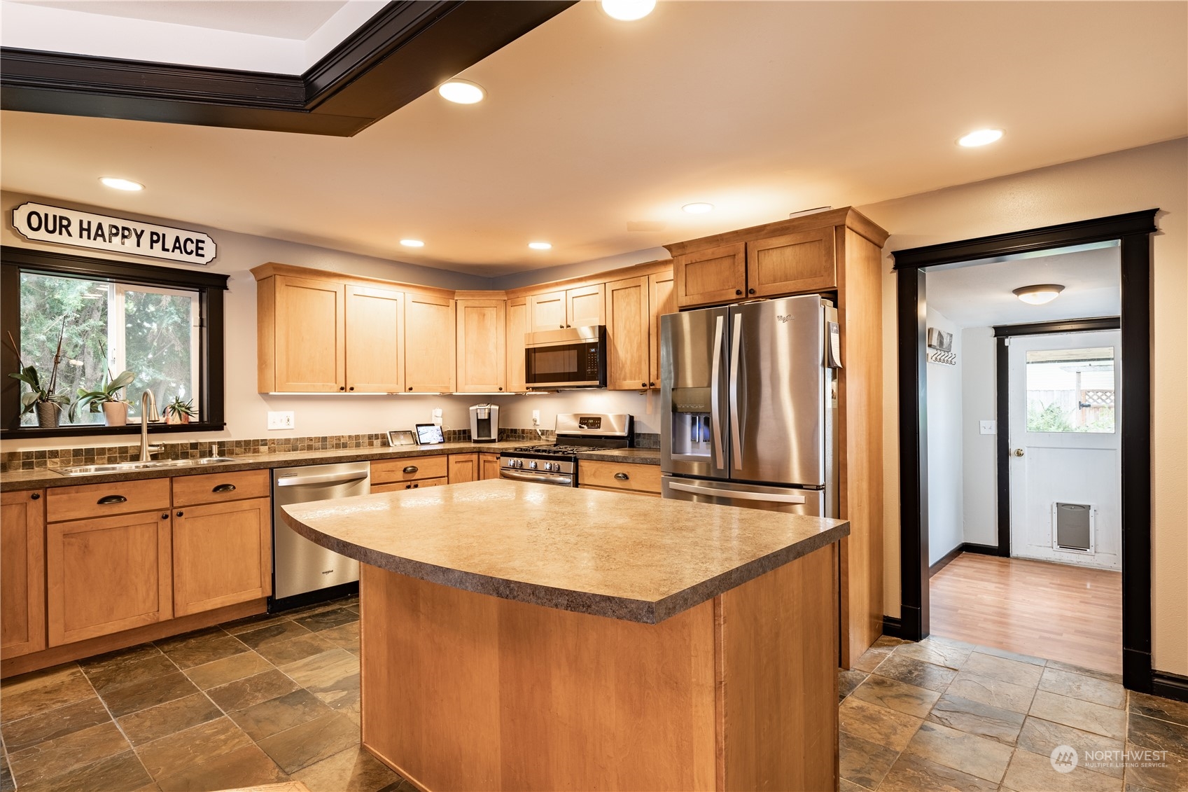 720 Greenleaf Avenue Burlington, WA 98233 - Photo 2 of 31 a kitchen with stainless steel appliances granite countertop a refrigerator a sink dishwasher a stove and a oven with wooden floor