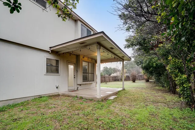 a view of a house with backyard and porch
