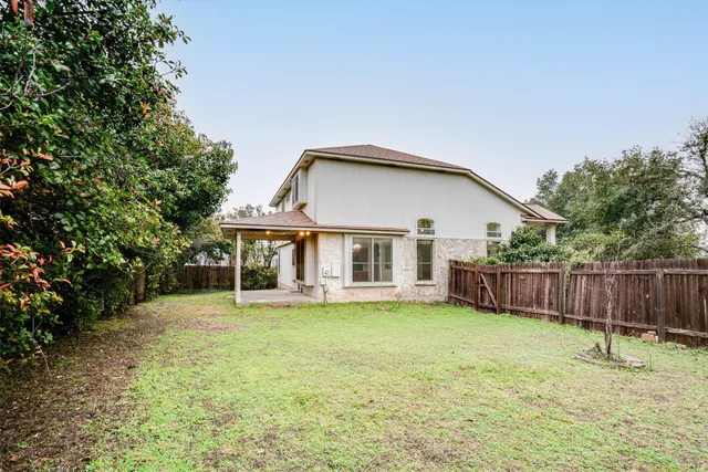 a view of a house with a yard and sitting area