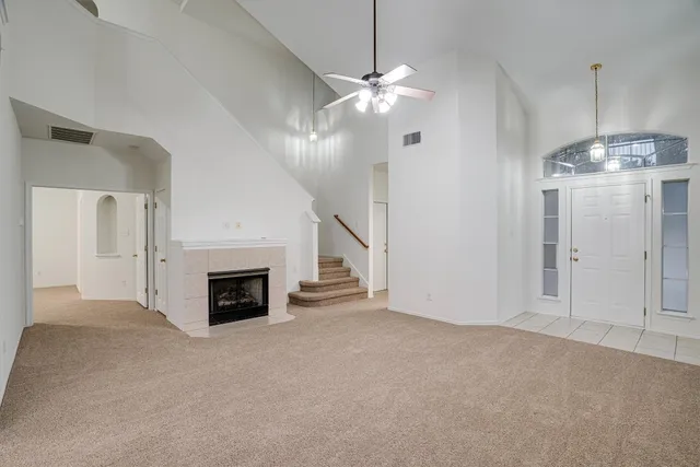 a view of empty room with fireplace and fan
