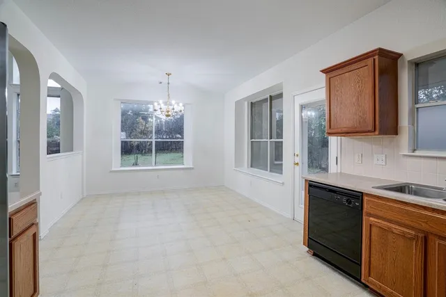 a view of a kitchen with a sink cabinet and a window
