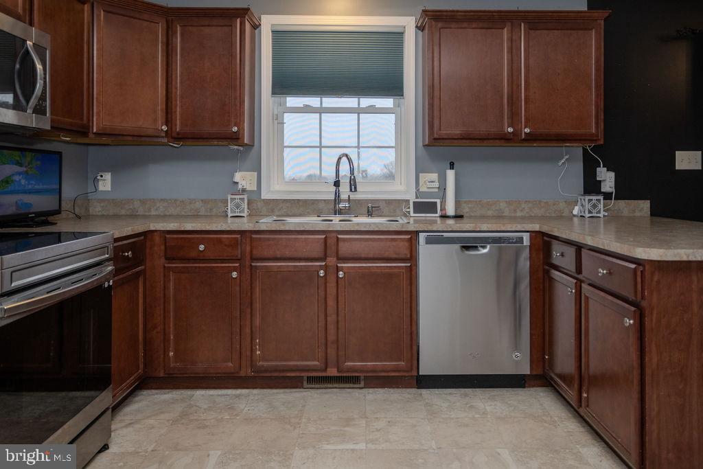 4482 Fort McCord Road Chambersburg, PA 17202 - Photo 16 of 47 a kitchen with stainless steel appliances granite countertop wooden cabinets a sink and a stove