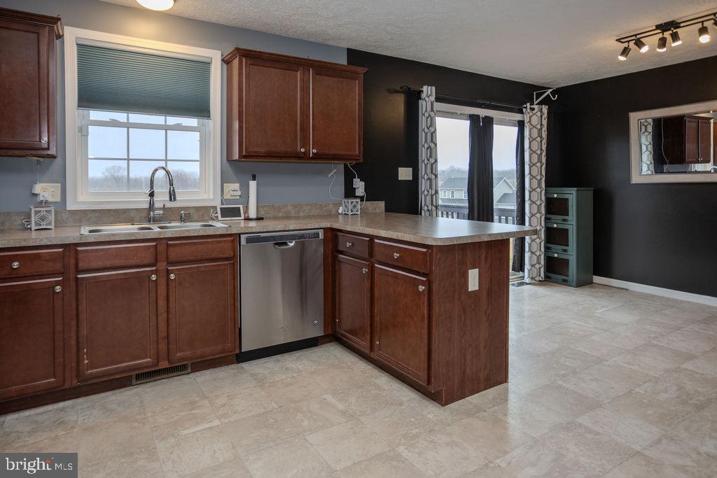 4482 Fort McCord Road Chambersburg, PA 17202 - Photo 21 of 47 a kitchen with kitchen island granite countertop a sink stove and cabinets