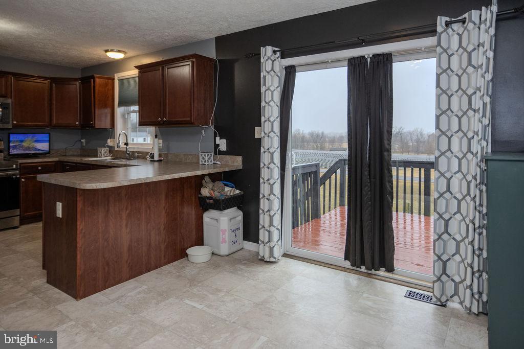 4482 Fort McCord Road Chambersburg, PA 17202 - Photo 22 of 47 a kitchen with kitchen island a counter top space a sink and cabinets