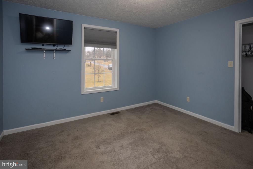 4482 Fort McCord Road Chambersburg, PA 17202 - Photo 32 of 47 a view of an empty room with a flat screen tv and windows
