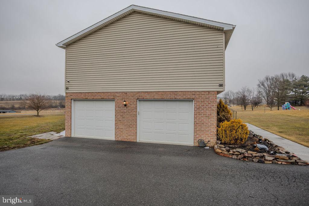 4482 Fort McCord Road Chambersburg, PA 17202 - Photo 6 of 47 a front view of a house with a yard and garage