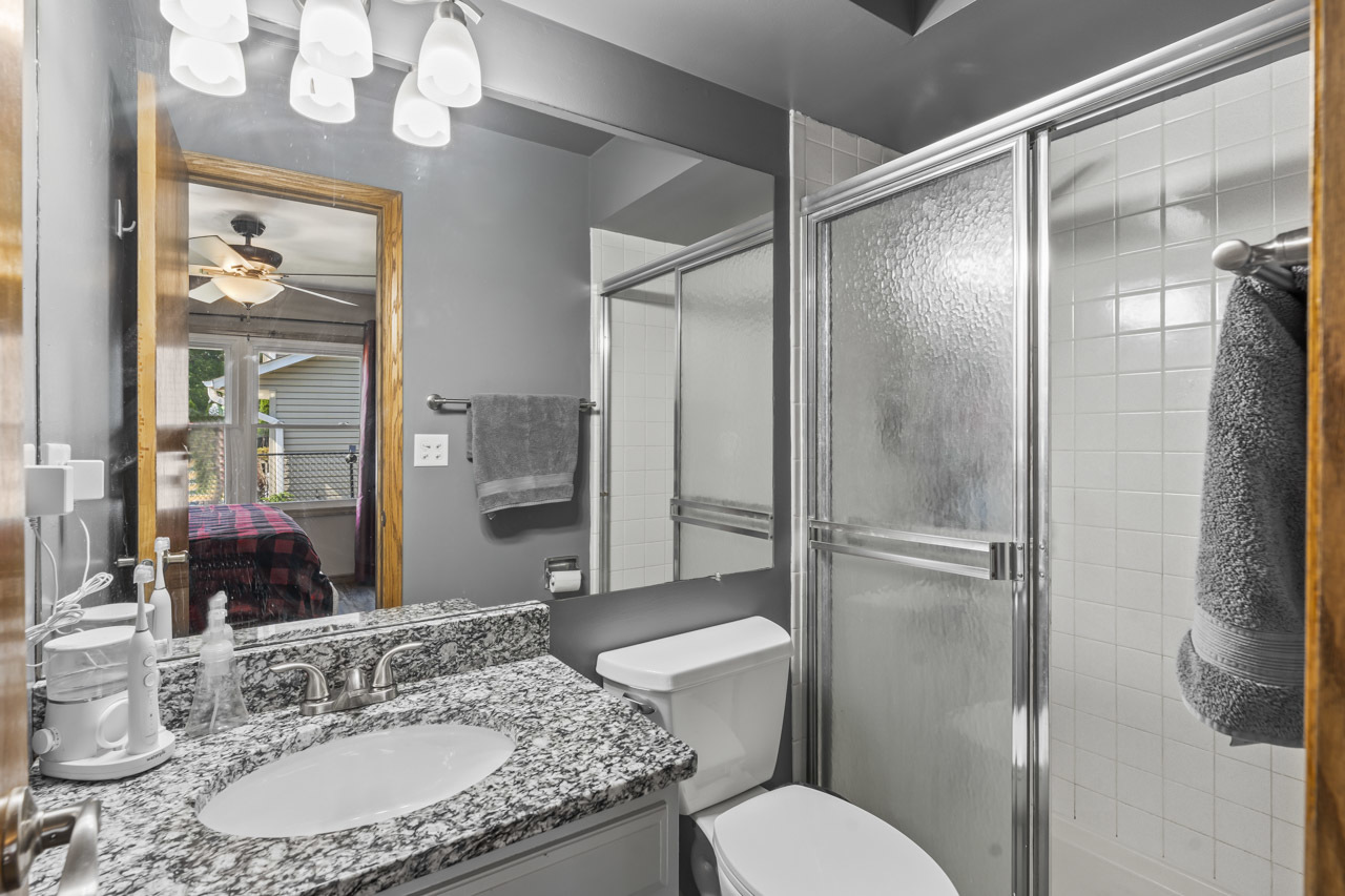34 Spring Valley Lane Streamwood, IL 60107 - Photo 11 of 24 a bathroom with a granite countertop sink toilet a mirror and shower