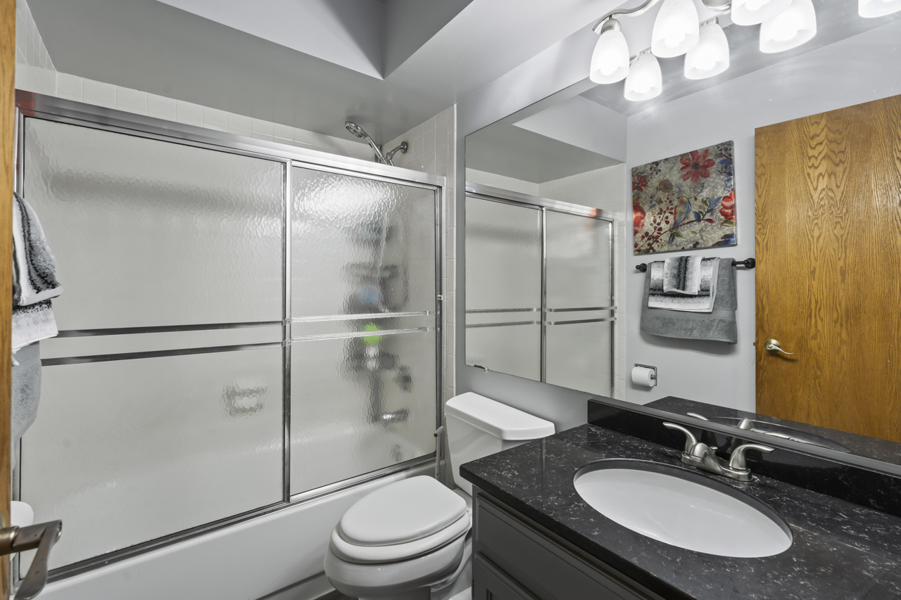 34 Spring Valley Lane Streamwood, IL 60107 - Photo 13 of 24 a bathroom with a granite countertop shower sink vanity and toilet