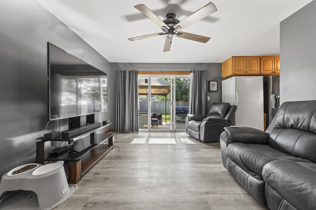 34 Spring Valley Lane Streamwood, IL 60107 - Photo 2 of 24 a living room with furniture and a flat screen tv