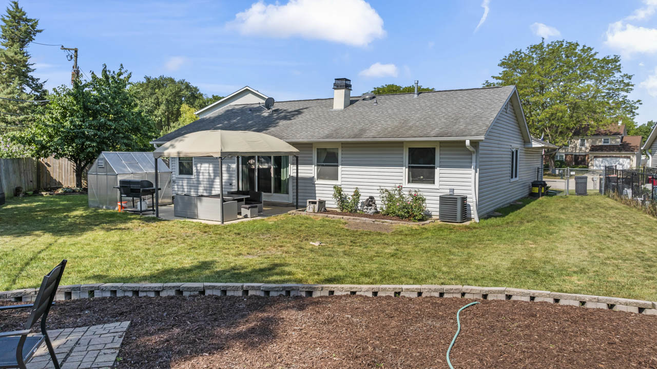 34 Spring Valley Lane Streamwood, IL 60107 - Photo 21 of 24 a view of a house with backyard porch and furniture