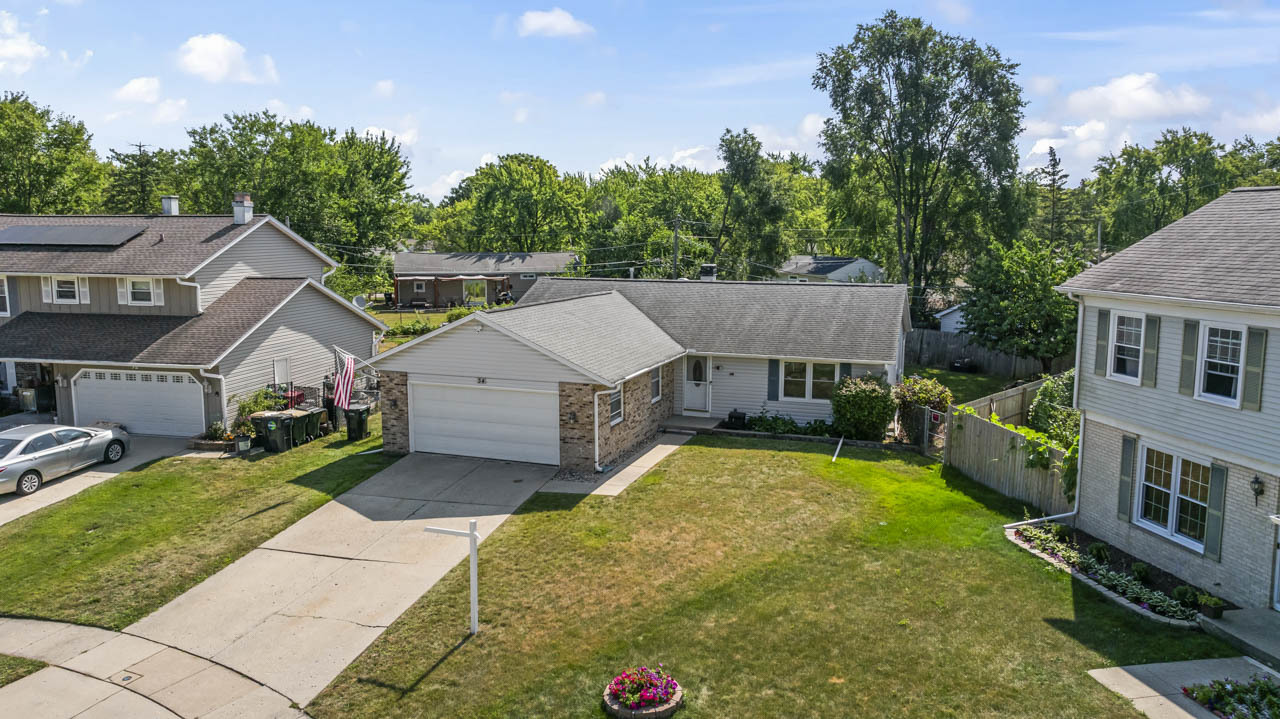 34 Spring Valley Lane Streamwood, IL 60107 - Photo 24 of 24 a view of a house with a big yard plants and large trees