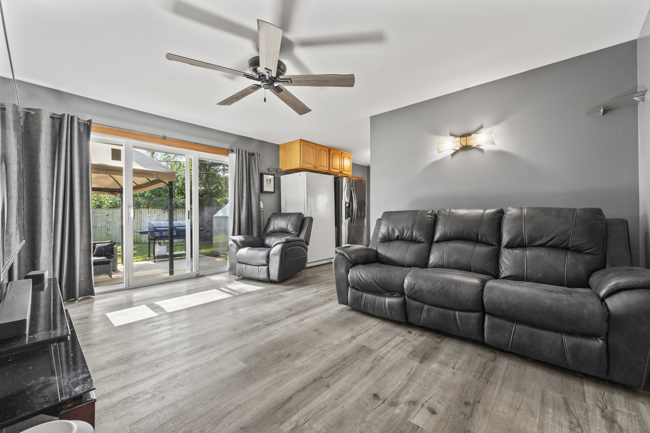 34 Spring Valley Lane Streamwood, IL 60107 - Photo 3 of 24 a living room with furniture and a flat screen tv