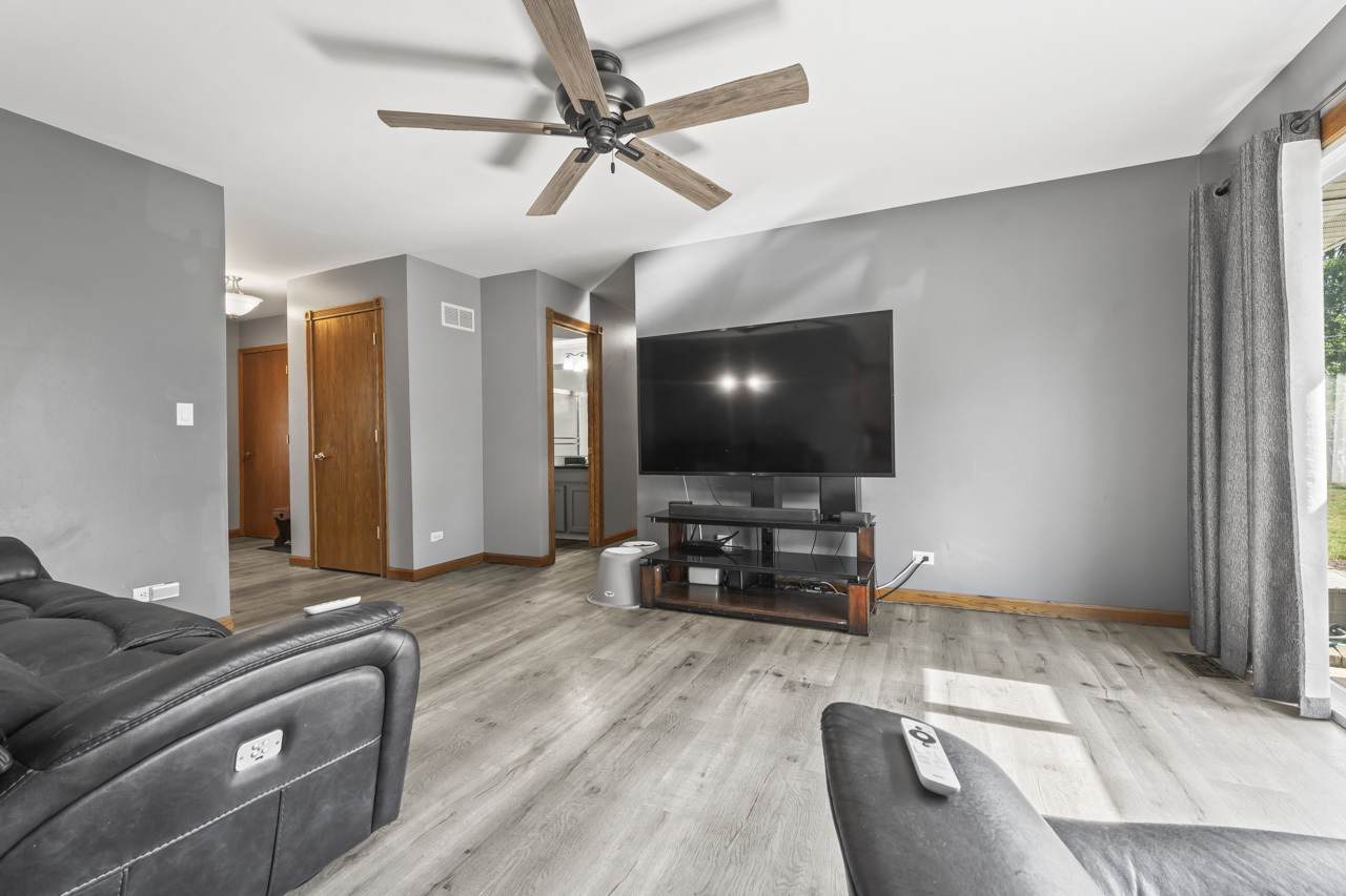 34 Spring Valley Lane Streamwood, IL 60107 - Photo 4 of 24 a living room with furniture and a flat screen tv
