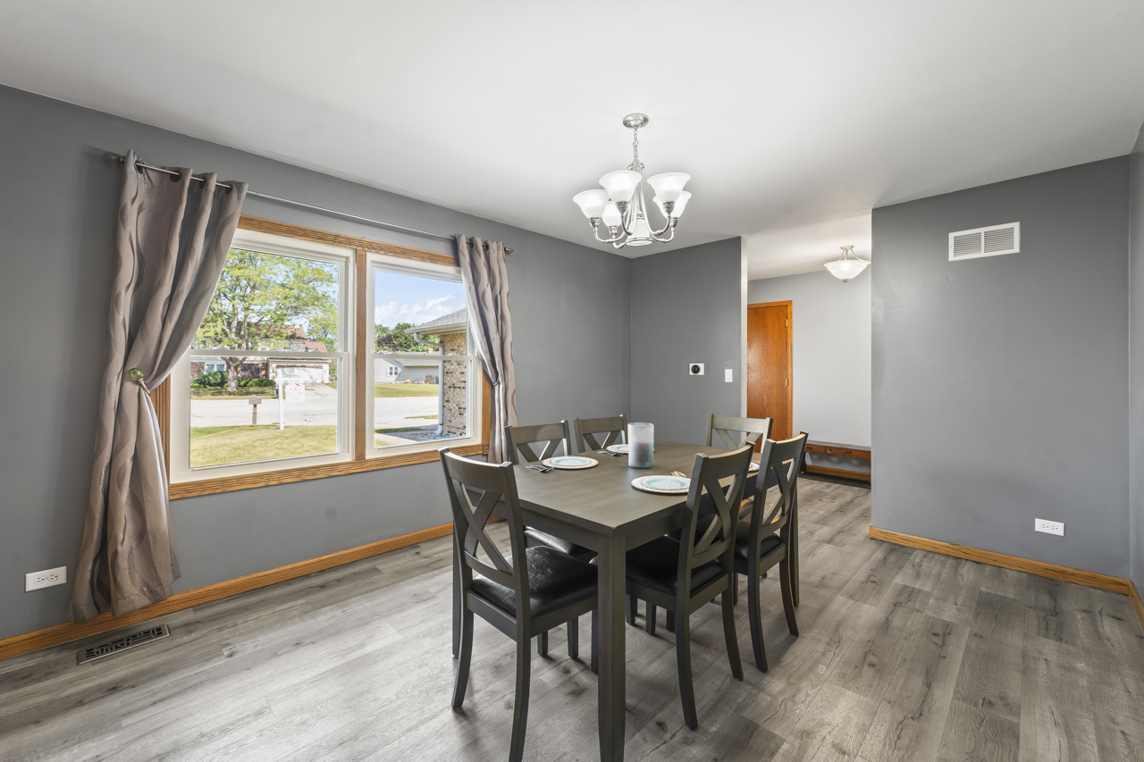 34 Spring Valley Lane Streamwood, IL 60107 - Photo 7 of 24 a view of a dining room with furniture wooden floor and chandelier