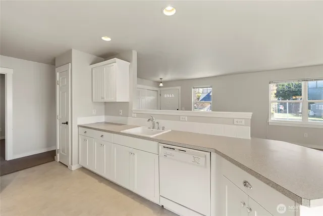 a kitchen with sink and cabinets