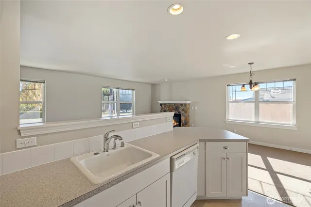 a kitchen with a sink cabinets and window