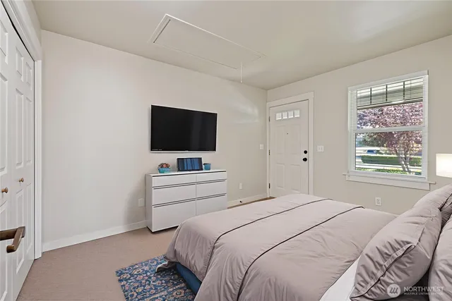 a bedroom with a bed and a flat screen tv