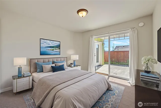 a bedroom with a bed and a painting on the wall