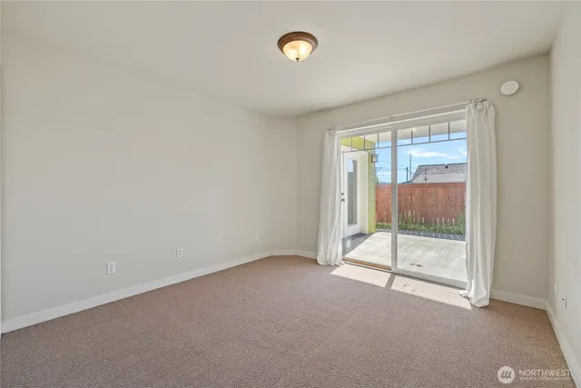 an empty room with sliding glass door