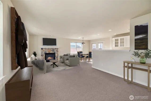a living room with furniture a fireplace and a flat screen tv