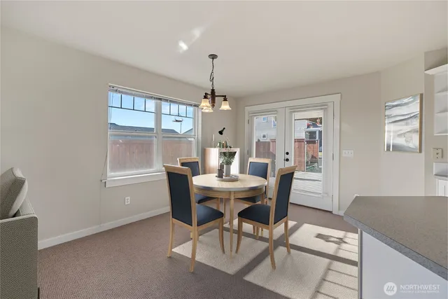 a dining room with furniture window and wooden floor
